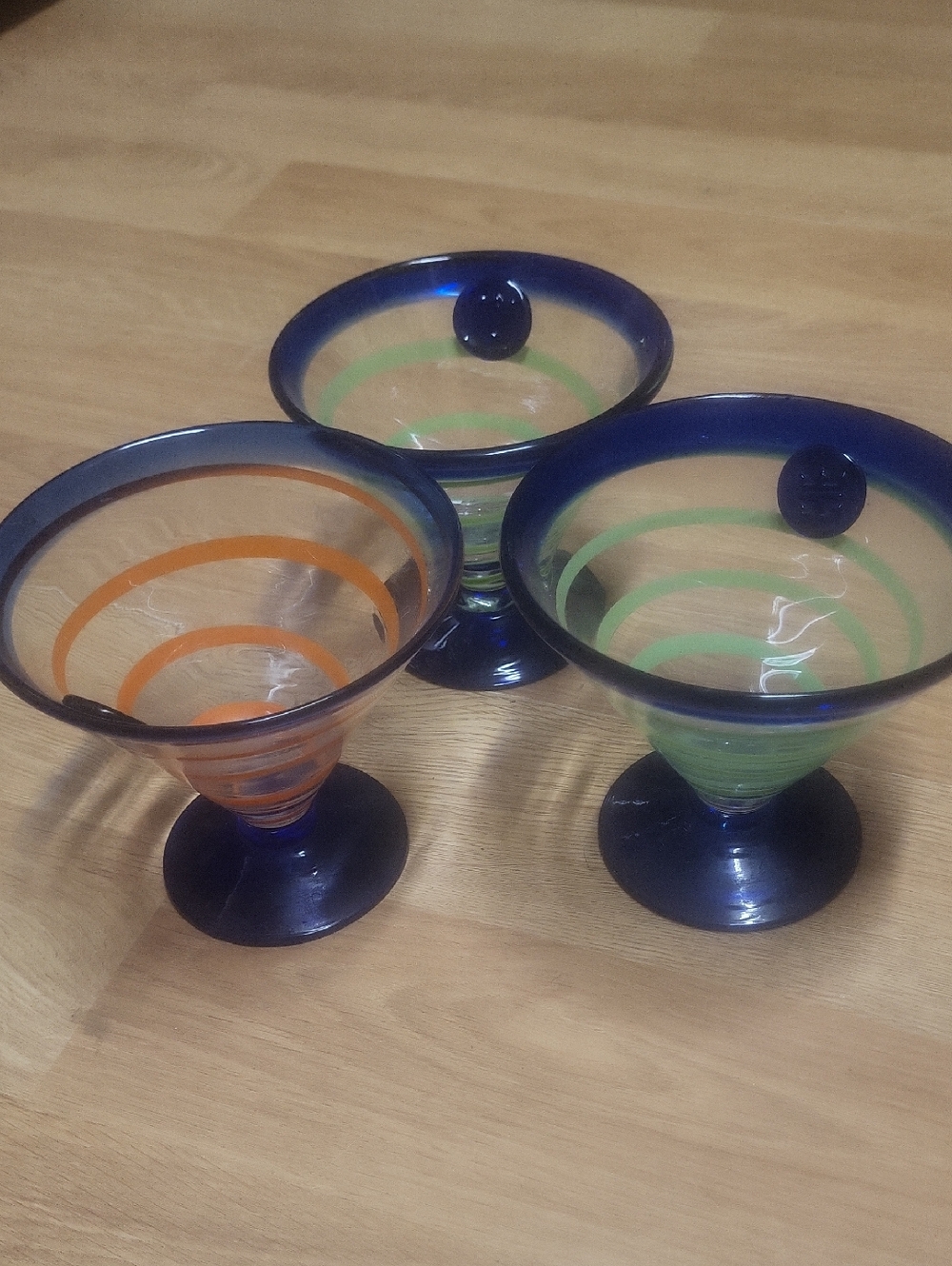 Kosta Boda Blue-Rimmed Martini Glasses with Green and Orange Spirals